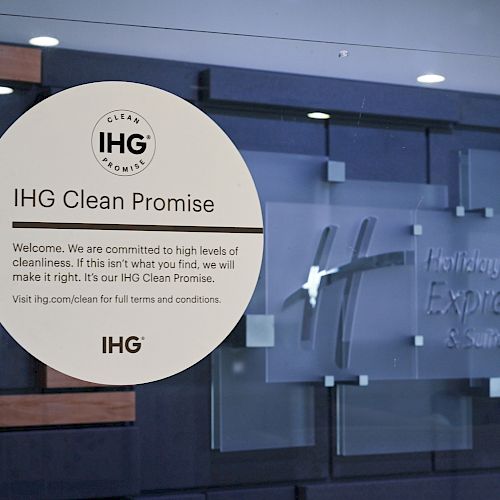 The image shows an IHG Clean Promise sign, noting their commitment to cleanliness. A heart decoration is also visible in the corner.